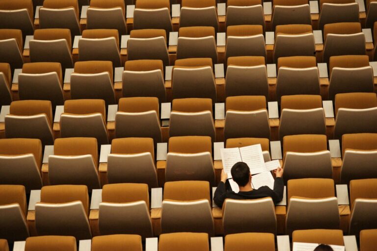person reading in empty lecture hall